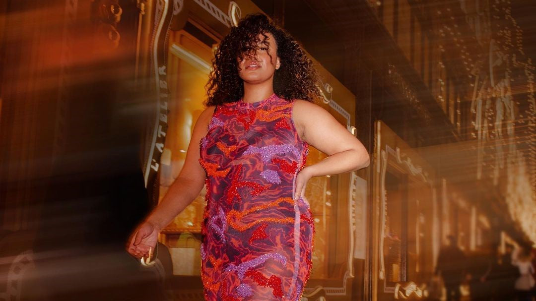 Plus-sized model wearing purple sleeveless maxi dress designed by Onalaja