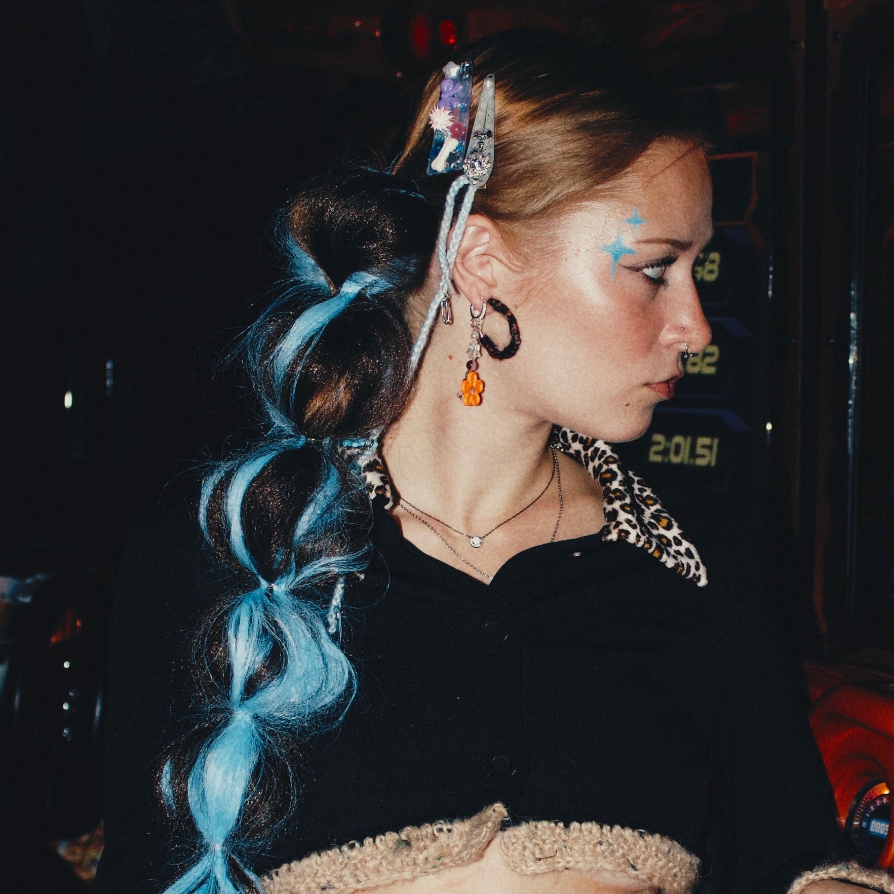 Fuzzy blue hoop earrings with colorful ball charms