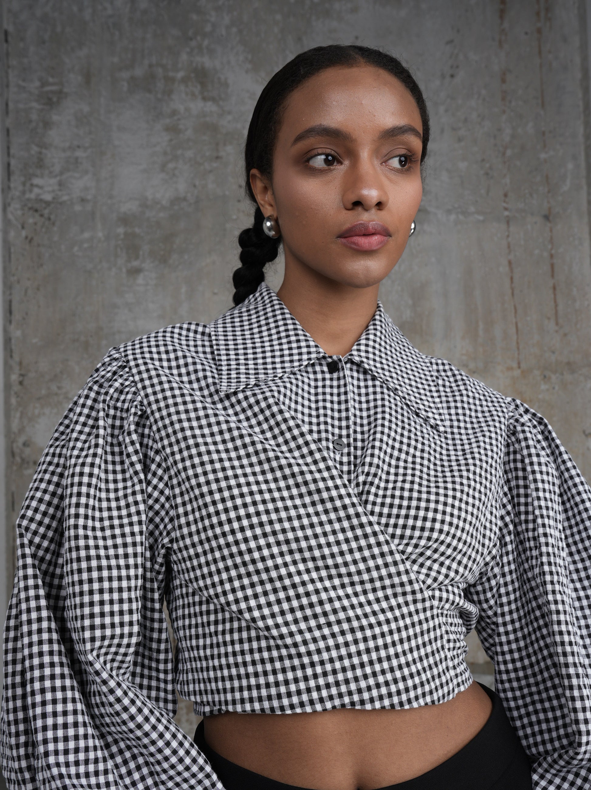 Wrap gingham shirt by Lagemma for Holocene. Has front ties and long puff sleeves