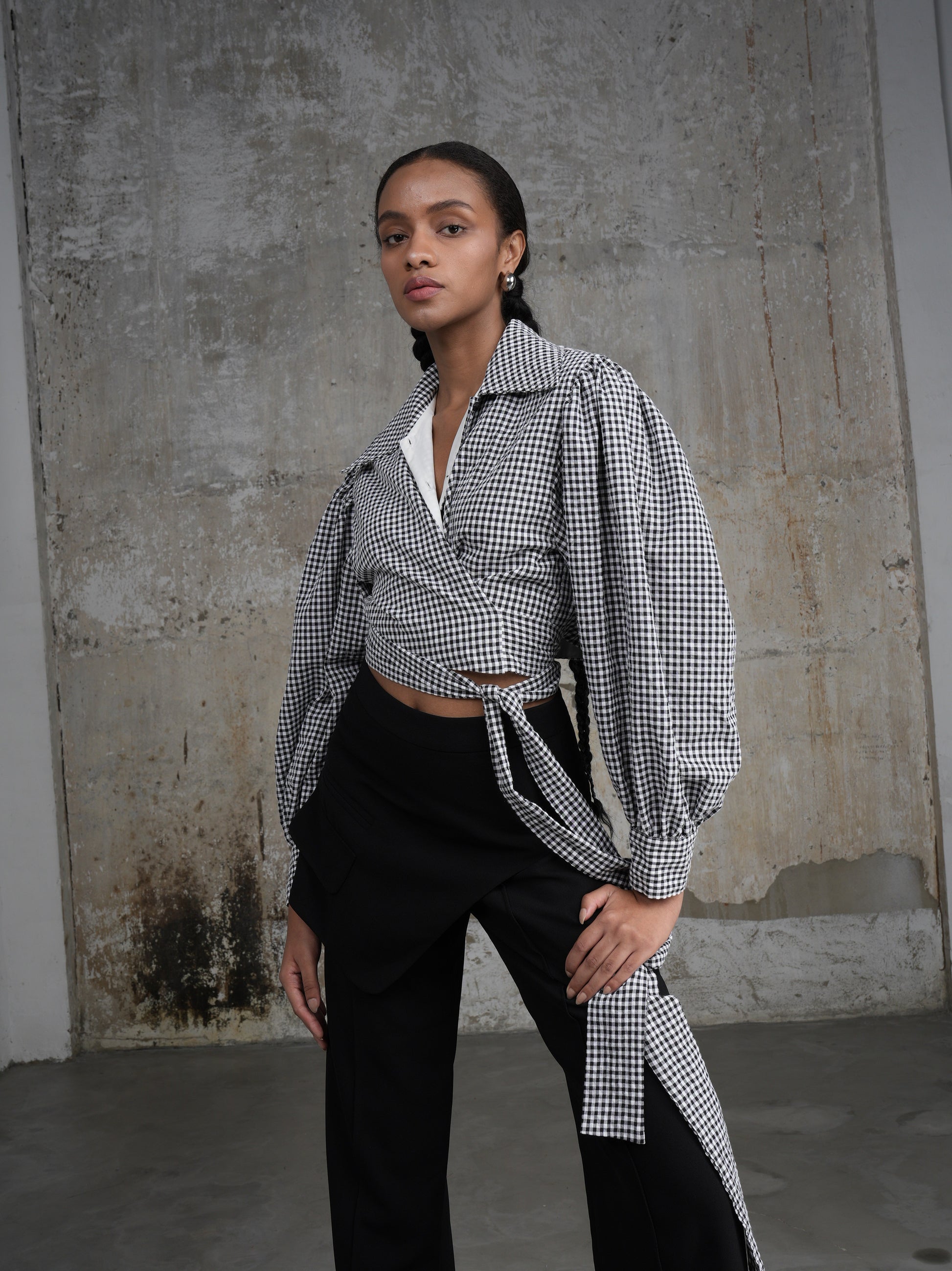 Wrap gingham shirt by Lagemma for Holocene. Has front ties and long puff sleeves